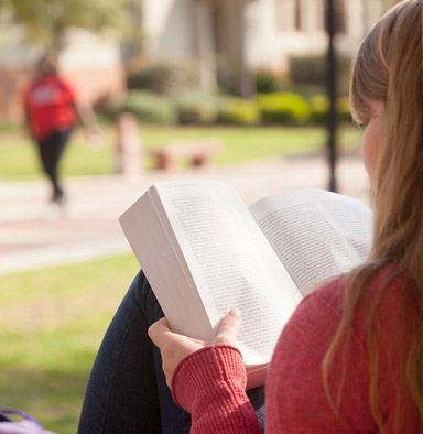 Close up shot of student reading a book